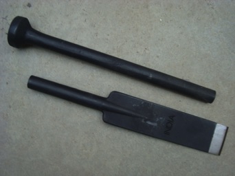 Post hole digger tamper bar. One piece forged. Heat treated chisel end. 1" round diameter, 72" long bar weighing 17 lb.